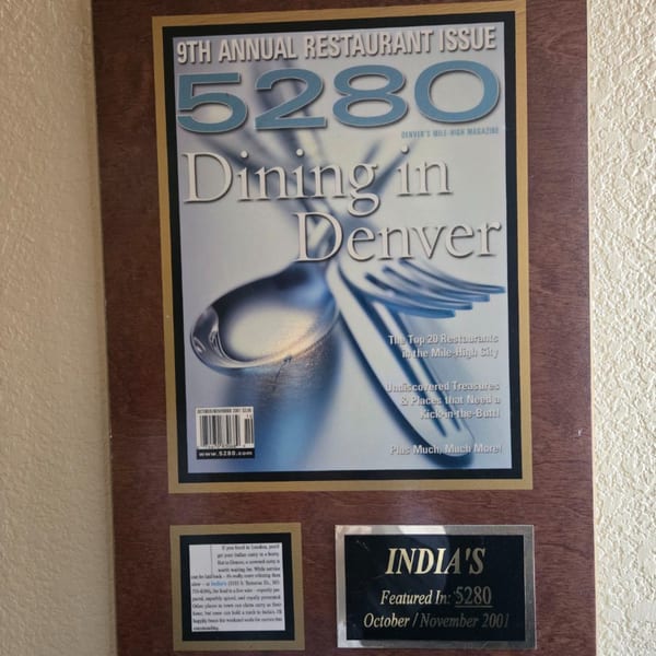 A framed 5280 magazine cover from 2001 featuring "Dining in Denver" and a plaque for INDIA'S Restaurant.